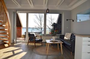 a living room with a couch and a table at Quartier Meerblick in Fehmarn