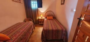 Postel nebo postele na pokoji v ubytování Huerta Carrión, Finca en El Pedroso