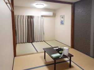 a room with a table and a room with a window at HOTEL HOUSE LEE in Tokyo