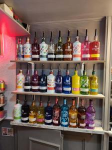 a shelf filled with lots of bottles of alcohol at Newholme Hotel in Blackpool