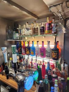 a bar filled with lots of bottles of alcohol at Newholme Hotel in Blackpool