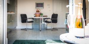 a room with a table and four chairs in it at Acorns with own hot tub, romantic escape, close to Lyme Regis in Uplyme +34 photos