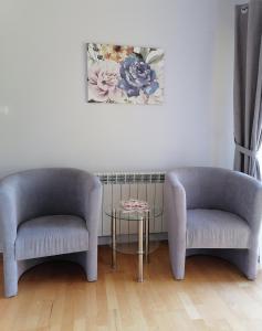 two chairs and a table in a room at Apartament Wschód Słońca Olecko in Olecko