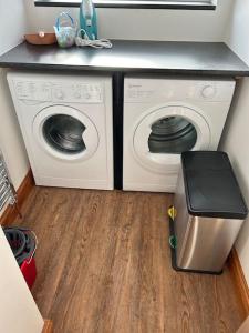 a kitchen with a washing machine and a washer and dryer at Rosy Bay Cottage in Scarborough