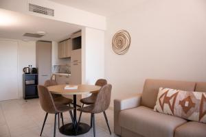 - un salon avec une table et un canapé dans l'établissement Résidence Pierre & Vacances Premium Horizon Golf, à Saint-Cyprien