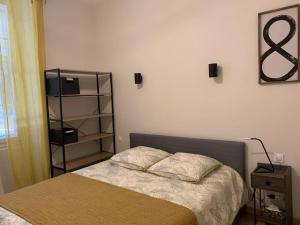 a bedroom with a bed and a book shelf at Cosy Joliette, central, climatisé, 2 chambres, WIFI, Garage in Marseille