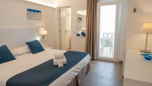 Łóżko lub łóżka w pokoju w obiekcie Hotel Colonial