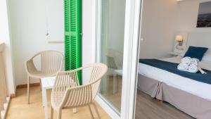 Łóżko lub łóżka w pokoju w obiekcie Hotel Colonial