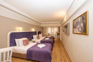 a group of three beds in a room at Grand Anka Hotel in Istanbul +216 photos