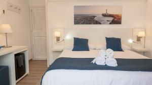 Łóżko lub łóżka w pokoju w obiekcie Hotel Colonial