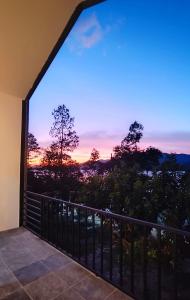 a balcony with a view of a sunset at เลคแค้มป์ รีสอร์ท in Kathun