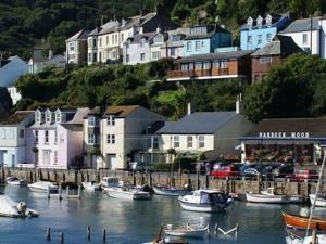a group of boats docked in a harbor with houses at Little Mainstone Guest House in Looe