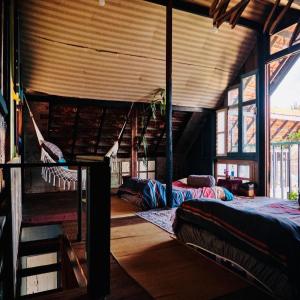 a room with two beds and a hammock in it at HEY! STORM HOME in Ấp Ða Lợi