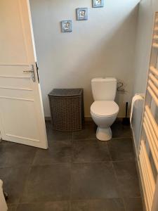 a bathroom with a white toilet in a room at Maison des Roses in Saint-Savinien +30 photos