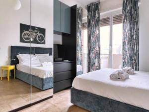 - une chambre avec 2 lits et un miroir dans l'établissement UR NEST Filanda, à Bologne