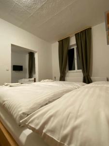 a bedroom with a large white bed with a window at Gasthaus zum Ochsen in Herrischried