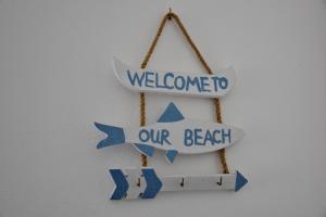 a sign that reads welcome to our beach at Sapore di mare Home in Santa Domenica
