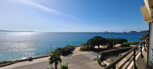 a view of the ocean from a balcony of a building at STUDIO LES CALANQUES in Ajaccio +10 photos