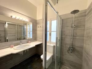 a bathroom with a toilet and a sink and a shower at Aeginia 2 in Perdika +27 photos