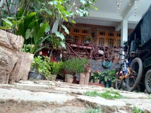 a bike parked in front of a house with plants at Nimsara Homestay in Ella