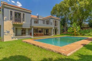 a house with a swimming pool in the yard at Lovely Family home in Bryanston in Johannesburg