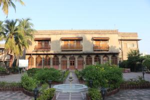 an old building with a fountain in front of it at Nilambag Palace Hotel in Bhavnagar