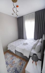 a bedroom with a large bed and a window at Classic Suite TS23 in Esenyurt