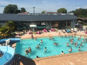 a group of people in a swimming pool at Camping la Haie Penée **** in Saint-Quentin-en-Tourmont