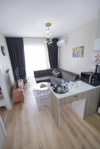 a living room with a couch and a table at Classic Suite TS23 in Esenyurt