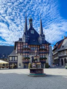 a large building with a tower on top of it at Traumhaus Wernigerode mit Sauna und Kamin in Wernigerode