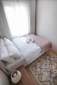 a bedroom with a bed with a window and a rug at Classic Suite TS22 in Esenyurt