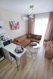 a living room with a couch and a table at Classic Suite TS22 in Esenyurt