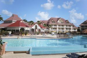 a swimming pool in front of a resort at Village Pierre & Vacances Sainte Luce in Sainte-Luce