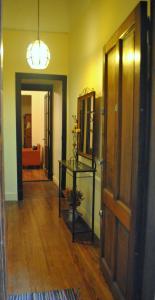 a room with a hallway with a door and a table at Arrabal Porteño in Buenos Aires