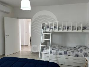 a bedroom with a bunk bed with a ladder at Villa Alysa - spiaggia a 400m in Porto Cesareo