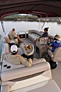 a group of people sitting in the back of a boat at Kubu & Kwena Lodge in Katima Mulilo
