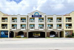 a large building with a davis inn sign on it at Days Inn Guam - Tamuning in Tamuning