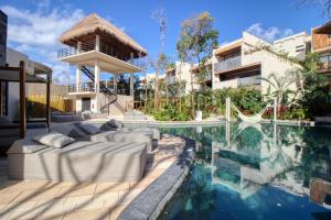 a swimming pool in the middle of a house with a swimming pool at Adora Tulum 406 at Av Kukulkan in Tulum