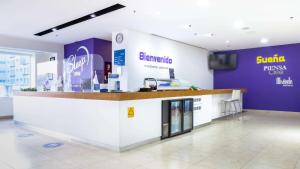 a kiosk in a store with purple walls at Sleep Inn Leon Antares in León