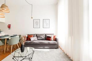 a living room with a couch and a table at LovelyStay - Cativo Studio Downtown by Metro Station in Porto