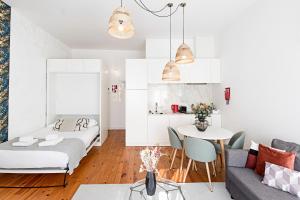 a living room with a bed and a table at LovelyStay - Cativo Studio Downtown by Metro Station in Porto