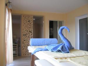a blue towel sitting on a bed in a room at Mira Guest House in Dobrinishte