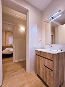 a bathroom with a sink and a mirror at Classbedroom Park Güell Apartment in Barcelona
