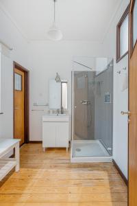 a bathroom with a shower and a sink at A Lodge in Blue in Aveiro
