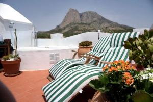 a group of green and white pillows on a balcony at La Campana de Finestrat in Finestrat