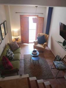 a living room with two couches and a table at La Campana de Finestrat in Finestrat