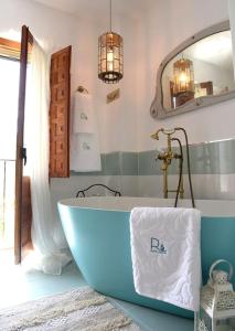 a bathroom with a bath tub and a mirror at La Campana de Finestrat in Finestrat