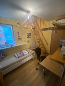 a bedroom with a bunk bed and a staircase at Ferienwohnung Saarleuchtturm in Ayl