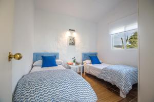 a bedroom with two beds and a window at BOLONIA HOUSE in Tarifa