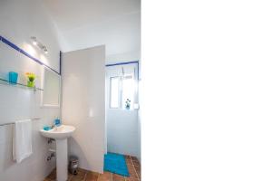 two pictures of a bathroom with a sink and a shower at BOLONIA HOUSE in Tarifa